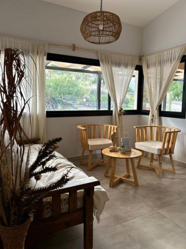 a living room with two chairs and a table at Cerros de Cafayate, Casa Nº2 in Cafayate