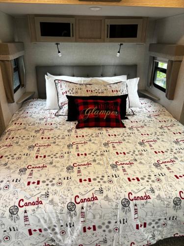 a bed in the back of a camper with canada written on it at Luxury Rocky Mountain Glamping in Golden Canada Family Friendly AC Campfire Northern Lights Stargazing in Golden