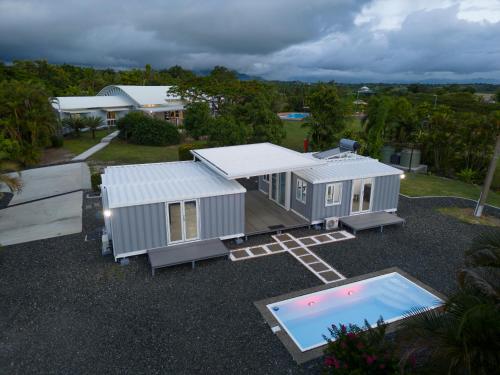 an overhead view of a tiny house and a pool at Luxury Hilltop Dual Villas With Stunning Sea Views & Pools ! in Lauwaki