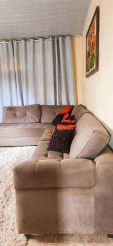 a brown couch in a living room with a window at Casa Chico Rei in Ouro Preto
