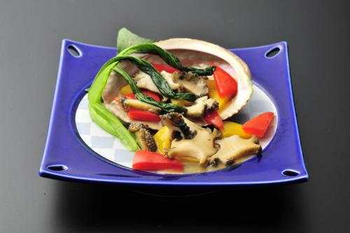 a blue plate with a taco with vegetables on it at Nisshokan Bettei Koyotei in Nagasaki