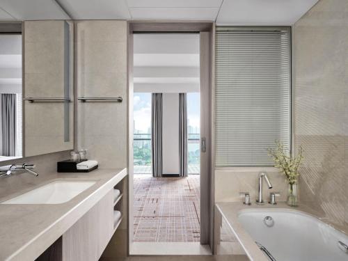 a bathroom with a tub and a large window at Cordis, Foshan, Lingnan Tiandi - Free Shuttle Bus to Canton Fair in Foshan