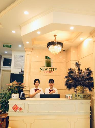 two men sitting at a counter in a new city hotel at NEW CITY HOTEL in Tây Ninh