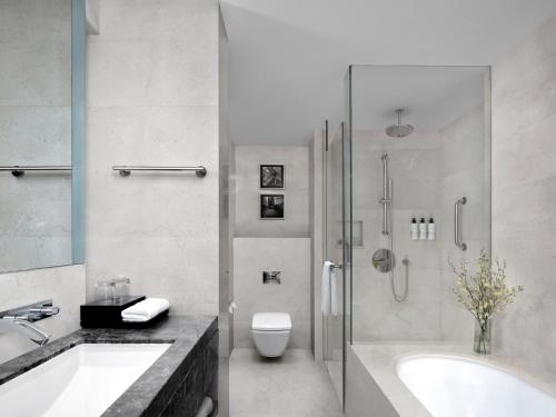 a bathroom with a tub and a toilet and a sink at Cordis, Foshan, Lingnan Tiandi - Free Shuttle Bus to Canton Fair in Foshan