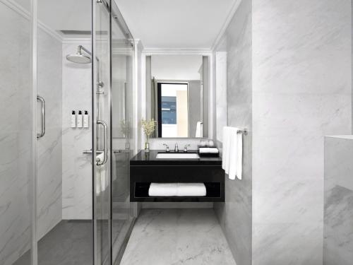 a bathroom with a sink and a shower at Cordis, Foshan, Lingnan Tiandi - Free Shuttle Bus to Canton Fair in Foshan