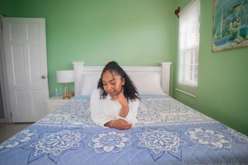 a young girl laying on a bed at Buena Vista SLC in Vieux Fort