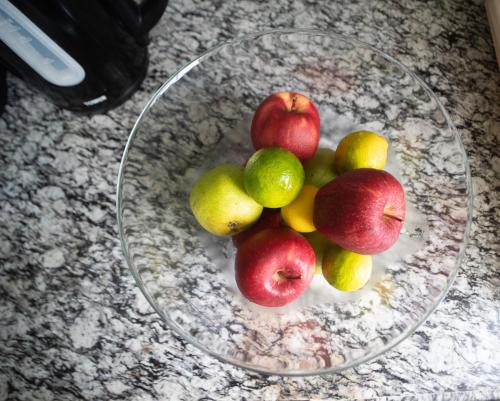 a glass bowl of apples and pears on a counter at Buena Vista SLC in Vieux Fort