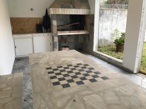 a kitchen with a checkered floor in a room at Large 2 floors in Carrasco in Montevideo