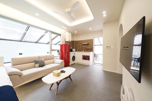 a living room with a couch and a table at Gyeongju Poolvilla Runtoyou in Gyeongju