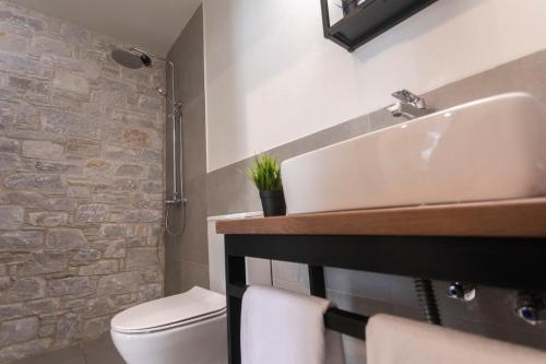 a bathroom with a sink and a toilet at Allure Luxury Villas 2, Skiathos in Skiathos Town