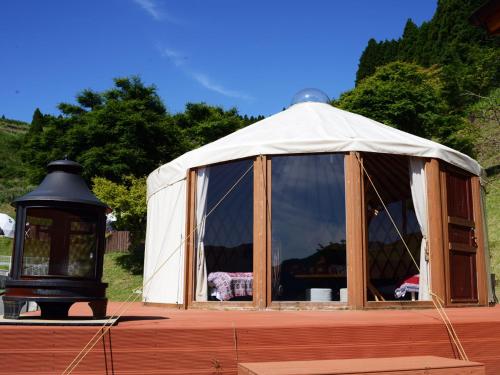 a yurt with a light in front of it at Minamiaso BlueBeeGarden in Minami Aso