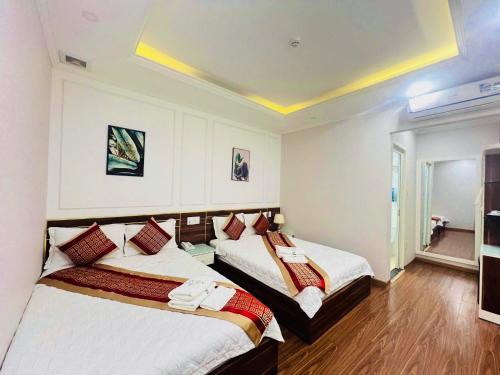 a hotel room with two beds in it at NEW CITY HOTEL in Tây Ninh