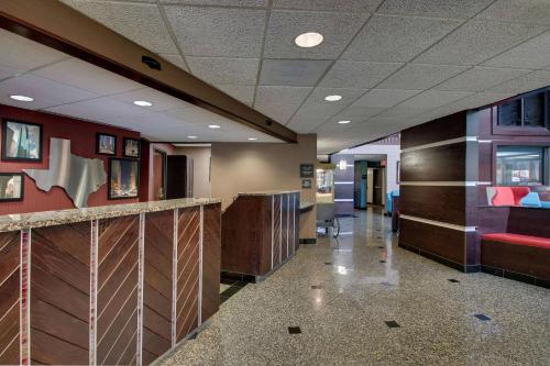 a hallway of a hospital with red walls and a lobby at Heritage Inn & Suites The Woodlands, Trademark by Wyndham in The Woodlands