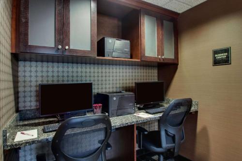 an office with two desks with two monitors and two chairs at Heritage Inn & Suites The Woodlands, Trademark by Wyndham in The Woodlands