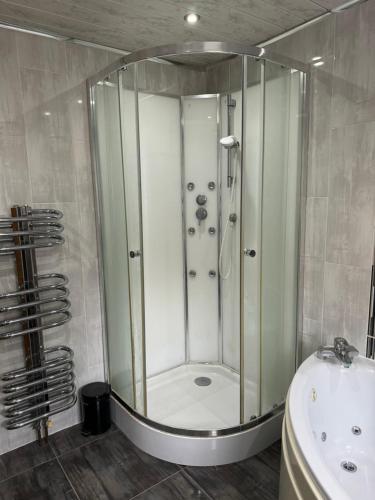 a bathroom with a shower and a sink at Peace House in Leeds
