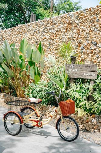a bike with a basket parked on a sidewalk at T Villas Kaeng Khoi in Sara Buri