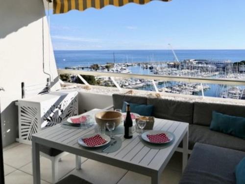 a table on a balcony with a view of a harbor at Studio vue mer climatisé, 2 à 4 pers., parking en option à Villeneuve-Loubet Plage - FR-1-252A-131 in Villeneuve-Loubet