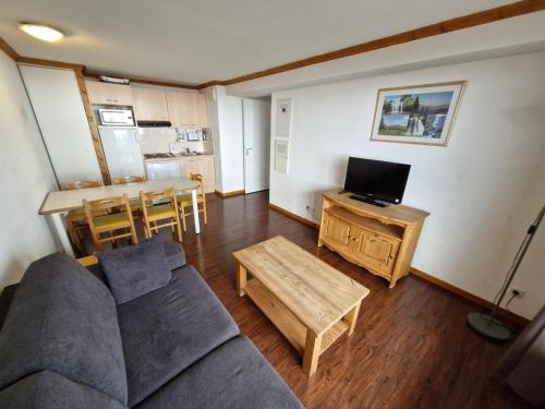 un salon avec un canapé et une table dans l'établissement Appartement spacieux avec terrasse et garage, accès piscine - FR-1-814-88, à Besse-et-Saint-Anastaise