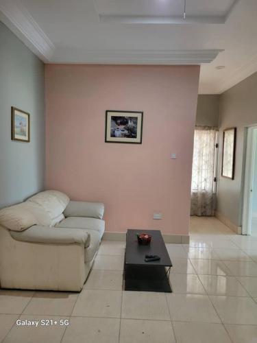 a living room with a couch and a coffee table at Casa Del Mar Apartments in Brufut