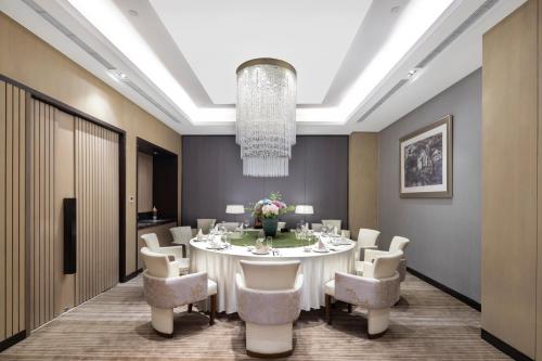 a large dining room with a white table and chairs at Hyatt House Shanghai Hongqiao CBD in Shanghai
