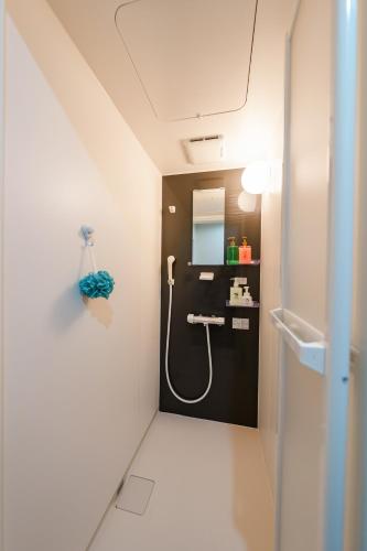 a bathroom with a sink and a shower in it at Osaka Namba Yeon House in Osaka