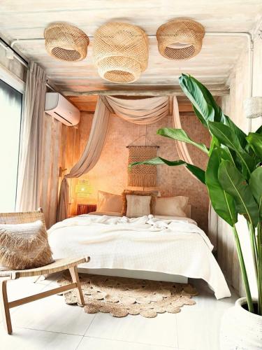 una camera da letto con un letto e una sedia di New Eco Bungalow, Bangrak Beach a Nathon Bay