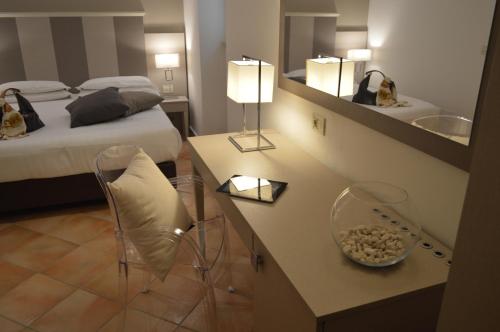 a hotel room with a bed and a mirror at Hotel Gajeta in Gaeta