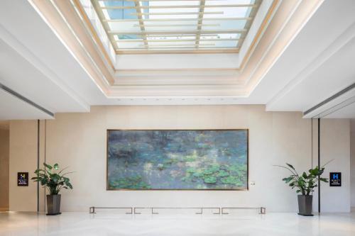 a large painting in a room with a ceiling at Hyatt House Shanghai Hongqiao CBD in Shanghai