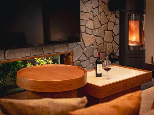 a table with a bottle of wine and a glass at Glamdy style hotel suite 川ノ音 in Kyū-karuisawa