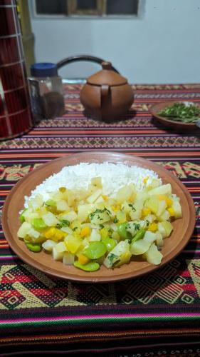 a plate of rice and vegetables on a table at Casitas Amantani in Amantani