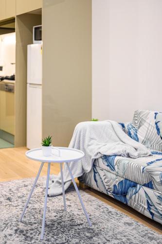 a white coffee table in a living room with a couch at Premium location one bedroom APT with secure car parking - 5 mins Train, Shops in Eastwood