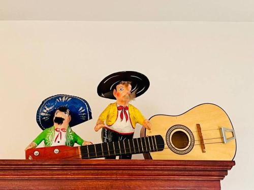 a figurine of two people standing on top of a guitar at Yellow Beachfront Dream Home in Rosarito Beach
