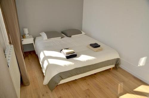 a bedroom with a bed with two towels on it at Le Solférino in Maisons-Laffitte