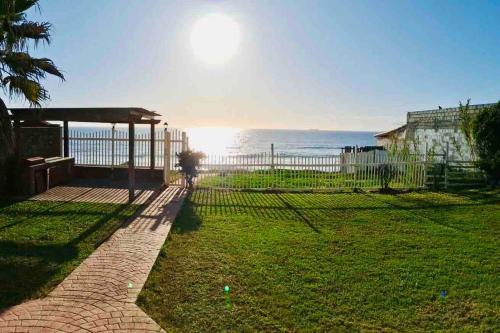 a view of the ocean from the backyard of a house at Yellow Beachfront Dream Home in Rosarito Beach