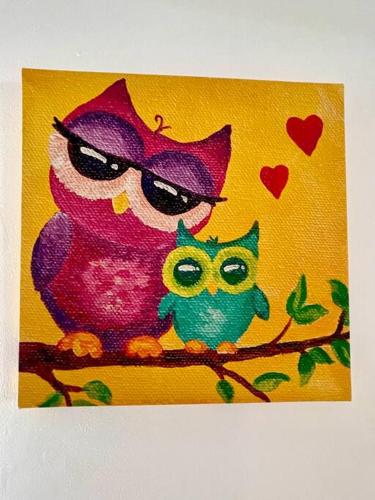 a painting of an owl sitting on a branch at Yellow Beachfront Dream Home in Rosarito Beach