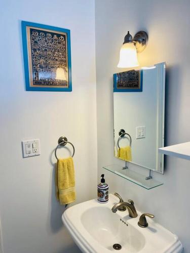 a white bathroom with a sink and a mirror at Yellow Beachfront Dream Home in Rosarito Beach