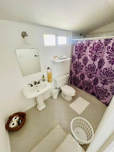a bathroom with a toilet and a sink at Yellow Beachfront Dream Home in Rosarito Beach