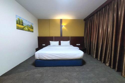 Ένα ή περισσότερα κρεβάτια σε δωμάτιο στο D'merlion Hotel Batam
