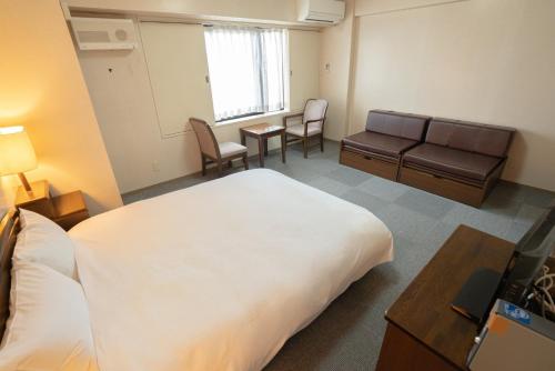 a hotel room with a large bed and a waiting room at Hotel Alpha Inn Akita - Vacation STAY 67295v in Akita