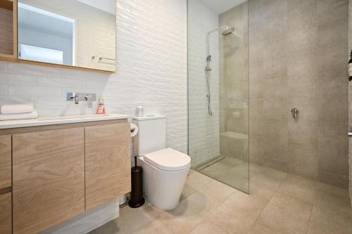 a bathroom with a toilet and a glass shower at Bokarina Beachside Escape - 6 Guests in Bokarina