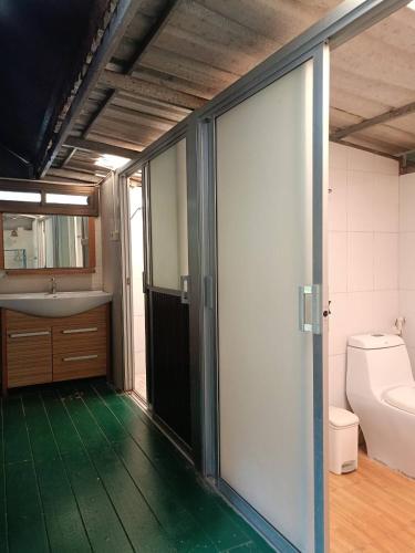 a bathroom with a toilet and a sink at Goldengold (Khaoyai) Resort & Spa in Mu Si