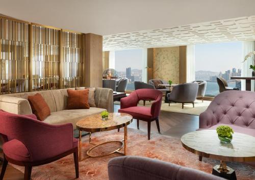 a hotel lobby with couches and chairs and tables at Mandarin Oriental, Hong Kong in Hong Kong