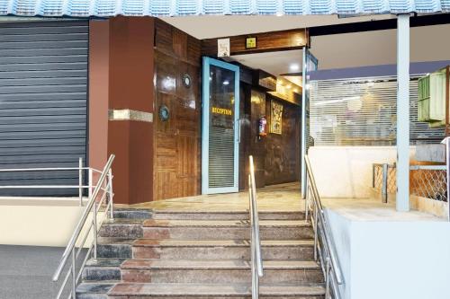 a building with stairs leading to a door at Super Hotel O Padmavathi Puram Near Railway Station in Tirupati