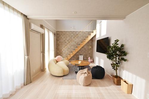 a living room with a staircase and a table at 8Room-千葉県八街市 in Yachimata