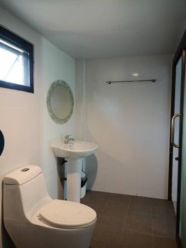 a bathroom with a toilet and a sink at Goldengold (Khaoyai) Resort & Spa in Mu Si