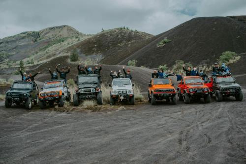 a group of people standing inront of four wheelers on a dirt road at Ayra Batur Sunrise Jeep in Kubupenlokan