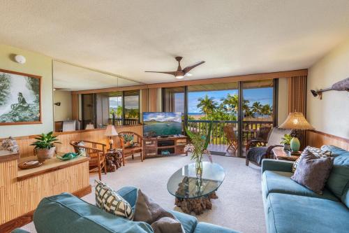 a living room with a blue couch and a table at Nihi Kai 806 condo in Koloa