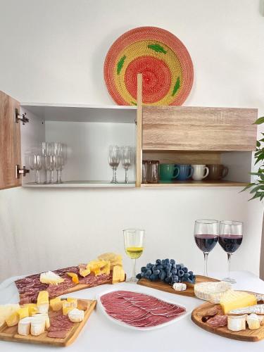 a table topped with cheese and wine glasses at Luxury One Bedroom Private Pool Villa in Jomtien in Jomtien Beach