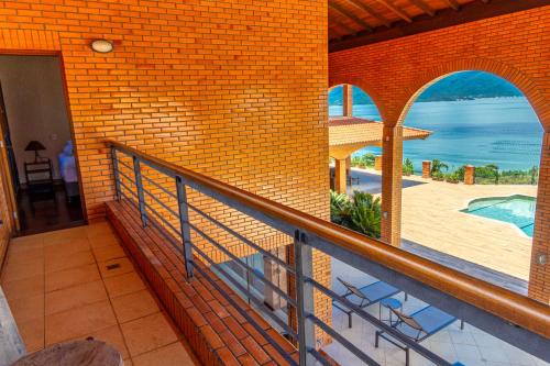 a balcony of a house with a view of the ocean at Mansão VOAR in Florianópolis