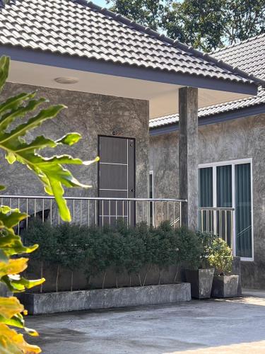 a house with a front porch with a gate at Sor Boutique Resort Chiangrai in Chiang Rai